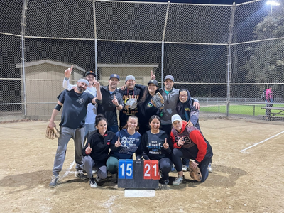 SLO Adult Softball team celebrating a win while posing for the camera