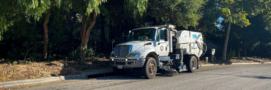 A picture of a San Luis Obispo Street Sweeper parked next to a curb