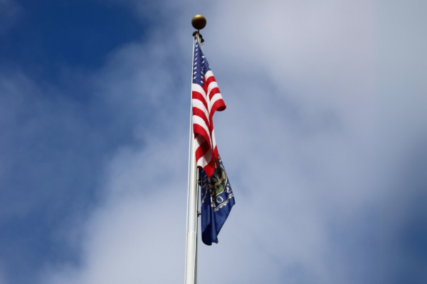A picture of a flag pole in front of City hall in San Luis Obispo